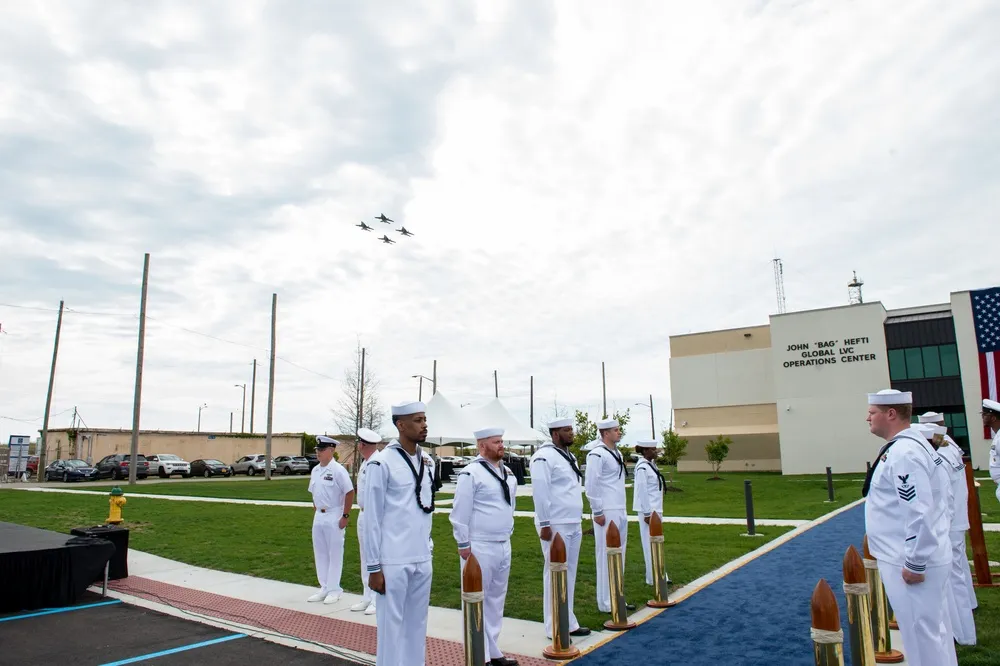 F/A-18s fly over the Hefti Global LVC Operations Center during the dedication ceremony